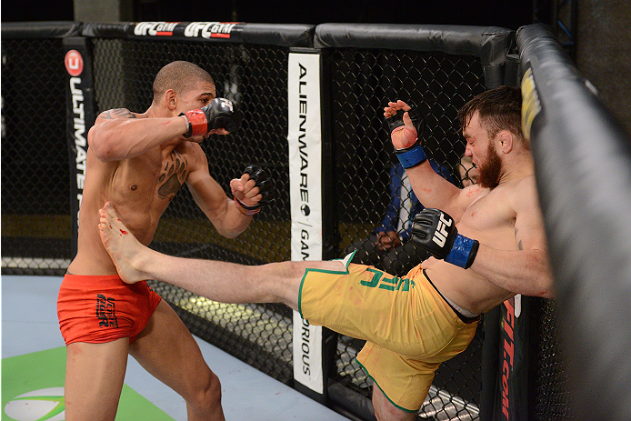 LACHUTE, CANADA - NOVEMBER 2: Team Australia fighter Brendan O'Reilly (R) kicks Team Canada fighter Kajan Johnson (L) in their welterweight bout during filming of The Ultimate Fighter Nations television series on November 2, 2013 in Lachute, Quebec, Cana