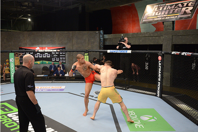 LACHUTE, CANADA - NOVEMBER 2: Team Canada fighter Kajan Johnson (L) kicks Team Australia fighter Brendan O'Reilly (R) in their welterweight bout during filming of The Ultimate Fighter Nations television series on November 2, 2013 in Lachute, Quebec, Cana