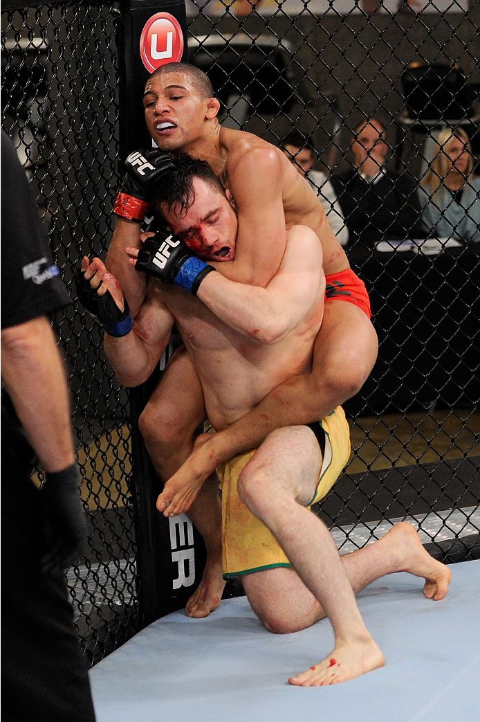 LACHUTE, CANADA - NOVEMBER 2: Team Canada fighter Kajan Johnson (red shorts) attempts submission against Team Australia fighter Brendan O'Reilly (green shorts) in their welterweight bout during filming of The Ultimate Fighter Nations television series on