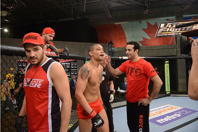LACHUTE, CANADA - NOVEMBER 2: Team Canada fighter Kajan Johnson celebrates with Coach Patrick Cote and his corner after defeating Team Australia fighter Brendan O'Reilly by submission in their welterweight bout during filming of The Ultimate Fighter Nati
