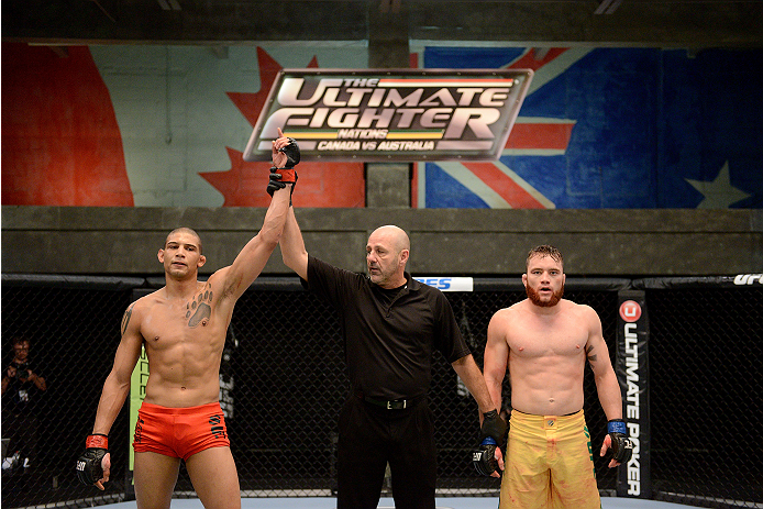 LACHUTE, CANADA - NOVEMBER 2: (L-R) Team Canada fighter Kajan Johnson is announced the winner by referee Yves Lavigne by submission against Team Australia fighter Brendan O'Reilly in their welterweight bout during filming of The Ultimate Fighter Nations