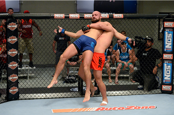 LAS VEGAS, NV - OCTOBER 24: (R-L) Team Edgar fighter Hector Urbina controls the body of Team Penn fighter Cathal Pendred in their preliminary fight during filming of season nineteen of The Ultimate Fighter on October 24, 2013 in Las Vegas, Nevada. (Photo