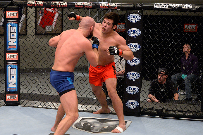 LAS VEGAS, NV - OCTOBER 24: (R-L) Team Edgar fighter Hector Urbina punches Team Penn fighter Cathal Pendred in their preliminary fight during filming of season nineteen of The Ultimate Fighter on October 24, 2013 in Las Vegas, Nevada. (Photo by Jeff Bott