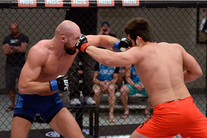 LAS VEGAS, NV - OCTOBER 24: (R-L) Team Edgar fighter Hector Urbina punches Team Penn fighter Cathal Pendred in their preliminary fight during filming of season nineteen of The Ultimate Fighter on October 24, 2013 in Las Vegas, Nevada. (Photo by Jeff Bott