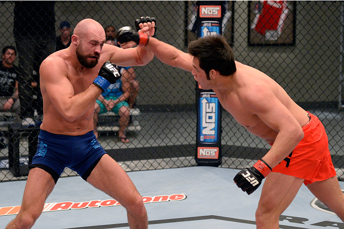 LAS VEGAS, NV - OCTOBER 24: (R-L) Team Edgar fighter Hector Urbina punches Team Penn fighter Cathal Pendred in their preliminary fight during filming of season nineteen of The Ultimate Fighter on October 24, 2013 in Las Vegas, Nevada. (Photo by Jeff Bott