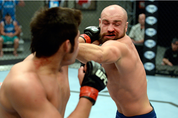 LAS VEGAS, NV - OCTOBER 24: (L-R) Team Edgar fighter Hector Urbina punches Team Penn fighter Cathal Pendred in their preliminary fight during filming of season nineteen of The Ultimate Fighter on October 24, 2013 in Las Vegas, Nevada. (Photo by Jeff Bott