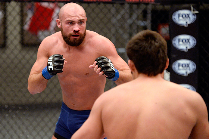 LAS VEGAS, NV - OCTOBER 24: (L-R) Team Penn fighter Cathal Pendred looks to strike Team Edgar fighter Hector Urbina in their preliminary fight during filming of season nineteen of The Ultimate Fighter on October 24, 2013 in Las Vegas, Nevada. (Photo by J