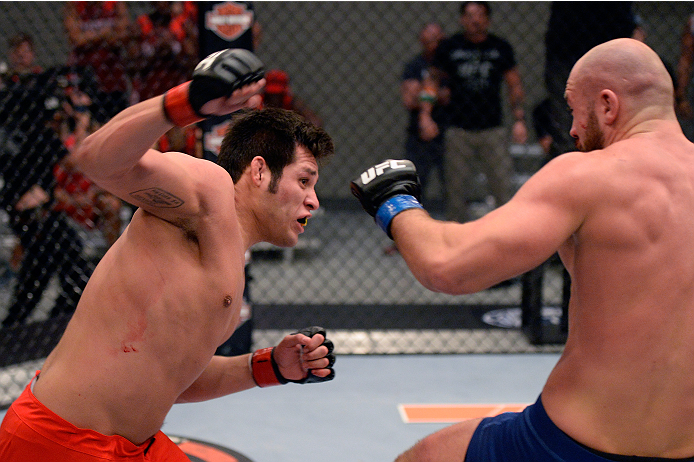 LAS VEGAS, NV - OCTOBER 24: (L-R) Team Edgar fighter Hector Urbina punches Team Penn fighter Cathal Pendred in their preliminary fight during filming of season nineteen of The Ultimate Fighter on October 24, 2013 in Las Vegas, Nevada. (Photo by Jeff Bott