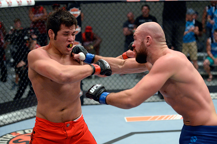 LAS VEGAS, NV - OCTOBER 24: (R-L) Team Penn fighter Cathal Pendred punches Team Edgar fighter Hector Urbina in their preliminary fight during filming of season nineteen of The Ultimate Fighter on October 24, 2013 in Las Vegas, Nevada. (Photo by Jeff Bott