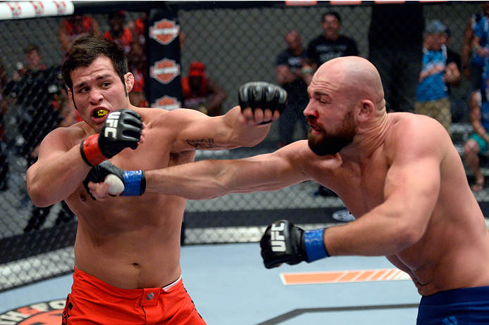 LAS VEGAS, NV - OCTOBER 24: (R-L) Team Penn fighter Cathal Pendred punches Team Edgar fighter Hector Urbina in their preliminary fight during filming of season nineteen of The Ultimate Fighter on October 24, 2013 in Las Vegas, Nevada. (Photo by Jeff Bott