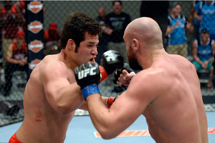 LAS VEGAS, NV - OCTOBER 24: (L-R) Team Edgar fighter Hector Urbina punches Team Penn fighter Cathal Pendred in their preliminary fight during filming of season nineteen of The Ultimate Fighter on October 24, 2013 in Las Vegas, Nevada. (Photo by Jeff Bott
