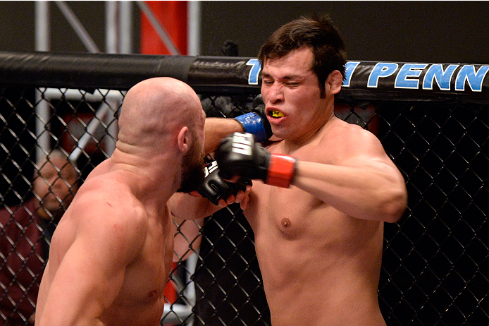 LAS VEGAS, NV - OCTOBER 24: (L-R) Team Penn fighter Cathal Pendred punches Team Edgar fighter Hector Urbina in their preliminary fight during filming of season nineteen of The Ultimate Fighter on October 24, 2013 in Las Vegas, Nevada. (Photo by Jeff Bott