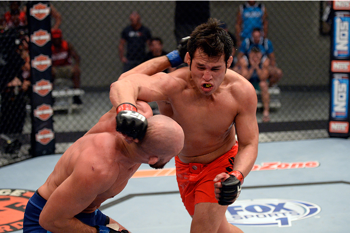 LAS VEGAS, NV - OCTOBER 24: (R-L) Team Edgar fighter Hector Urbina punches Team Penn fighter Cathal Pendred in their preliminary fight during filming of season nineteen of The Ultimate Fighter on October 24, 2013 in Las Vegas, Nevada. (Photo by Jeff Bott