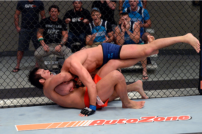 LAS VEGAS, NV - OCTOBER 24: (L-R) Team Edgar fighter Hector Urbina attempts a submission against Team Penn fighter Cathal Pendred in their preliminary fight during filming of season nineteen of The Ultimate Fighter on October 24, 2013 in Las Vegas, Nevad
