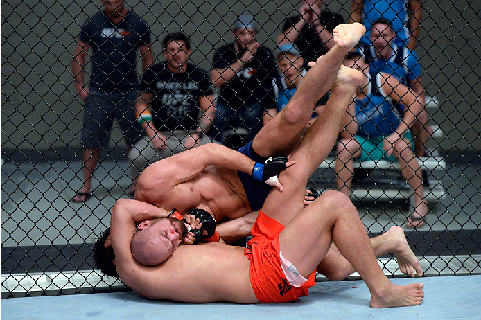 LAS VEGAS, NV - OCTOBER 24: (L-R) Team Edgar fighter Hector Urbina attempts a submission against Team Penn fighter Cathal Pendred in their preliminary fight during filming of season nineteen of The Ultimate Fighter on October 24, 2013 in Las Vegas, Nevad