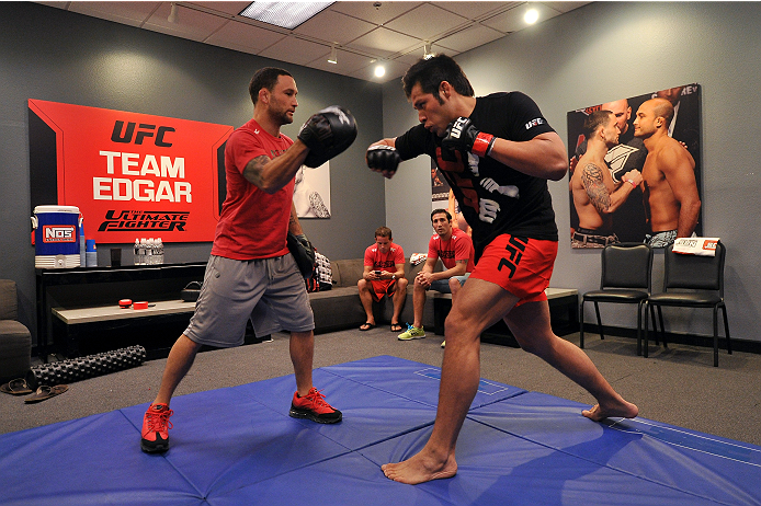 LAS VEGAS, NV - OCTOBER 24: (L-R) Coach Frankie Edgar trains his fighter Hector Urbina before facing Team Penn fighter Cathal Pendred in their preliminary fight during filming of season nineteen of The Ultimate Fighter on October 24, 2013 in Las Vegas, N
