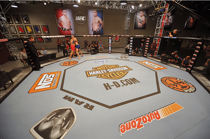 LAS VEGAS, NV - OCTOBER 24: (L-R) Team Edgar fighter Hector Urbina controls the body of Team Penn fighter Cathal Pendred in their preliminary fight during filming of season nineteen of The Ultimate Fighter on October 24, 2013 in Las Vegas, Nevada. (Photo