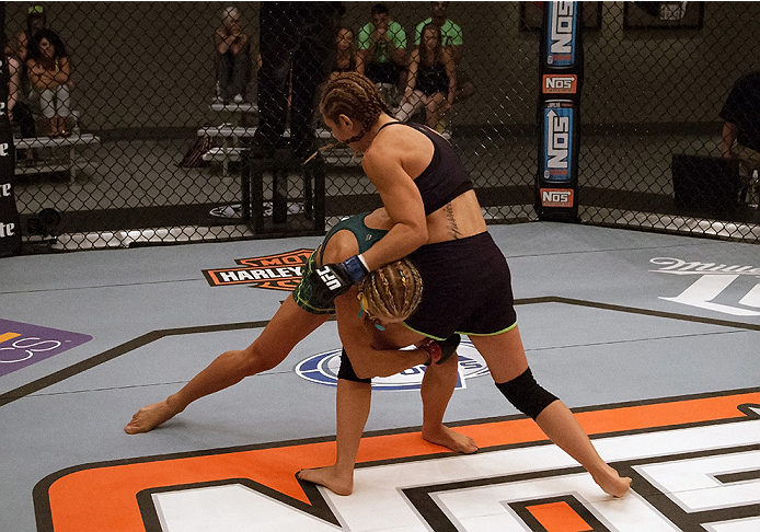 LAS VEGAS, NV - JULY 18: (L-R) Team Pettis fighter Felice Herrig takes down team Melendez fighter Heather Jo Clark during filming of season twenty of The Ultimate Fighter on July 18, 2014 in Las Vegas, Nevada. (Photo by Brandon Magnus/Zuffa LLC/Zuffa LLC