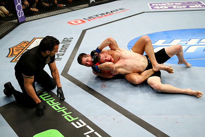 NEWARK, NJ - APRIL 27: The referee looks on as Steven Siler chokes Kurt Holobaugh in their featherweight bout during the UFC 159 event at the Prudential Center on April 27, 2013 in Newark, New Jersey. (Photo by Al Bello/Zuffa LLC/Zuffa LLC Via Getty Imag