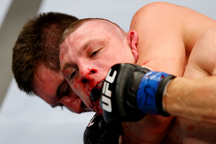 NEWARK, NJ - APRIL 27: Kurt Holobaugh tries to get loose from Steven Siler in their featherweight bout during the UFC 159 event at the Prudential Center on April 27, 2013 in Newark, New Jersey. (Photo by Al Bello/Zuffa LLC/Zuffa LLC Via Getty Images)