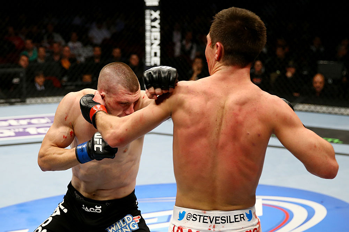 NEWARK, NJ - APRIL 27: (L-R) Kurt Holobaugh throws a punch against Steven Siler in their featherweight bout during the UFC 159 event at the Prudential Center on April 27, 2013 in Newark, New Jersey. (Photo by Al Bello/Zuffa LLC/Zuffa LLC Via Getty Images