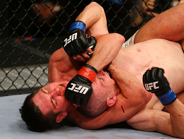 NEWARK, NJ - APRIL 27: Steven Siler chokes Kurt Holobaugh in their featherweight bout during the UFC 159 event at the Prudential Center on April 27, 2013 in Newark, New Jersey. (Photo by Al Bello/Zuffa LLC/Zuffa LLC Via Getty Images)
