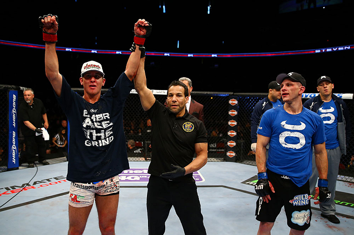 NEWARK, NJ - APRIL 27: Steven Siler (L) is announced winner by unanimous decision in his featherweight bout against Kurt Holobaugh (R) during the UFC 159 event at the Prudential Center on April 27, 2013 in Newark, New Jersey. (Photo by Al Bello/Zuffa LL