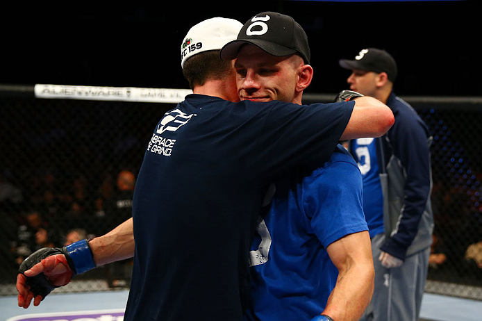 NEWARK, NJ - APRIL 27: Steven Siler (L) is hugs opponent Kurt Holobaugh (R) after winning their featherweight bout by unanimous decision during the UFC 159 event at the Prudential Center on April 27, 2013 in Newark, New Jersey. (Photo by Al Bello/Zuffa