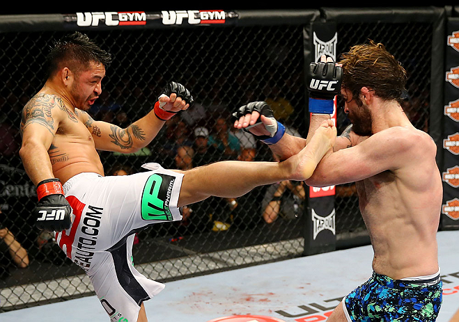 NEWARK, NJ - APRIL 27: Cody McKenzie (R) blocks a kick from Leonard Garcia (L) in their featherweight bout during the UFC 159 event at the Prudential Center on April 27, 2013 in Newark, New Jersey. (Photo by Al Bello/Zuffa LLC/Zuffa LLC Via Getty Images