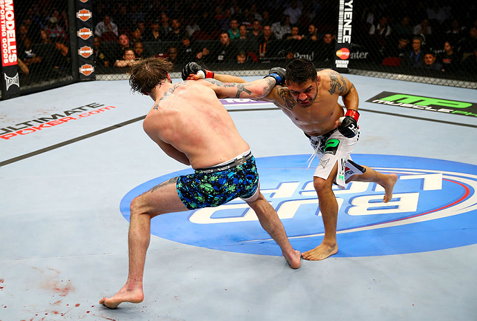 NEWARK, NJ - APRIL 27: Cody McKenzie (L) and Leonard Garcia (R) exchange punches in their featherweight bout during the UFC 159 event at the Prudential Center on April 27, 2013 in Newark, New Jersey. (Photo by Al Bello/Zuffa LLC/Zuffa LLC Via Getty Imag