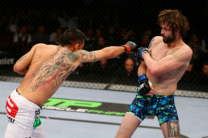 NEWARK, NJ - APRIL 27: Leonard Garcia (L) throws a punch against Cody McKenzie (R) in their featherweight bout during the UFC 159 event at the Prudential Center on April 27, 2013 in Newark, New Jersey. (Photo by Al Bello/Zuffa LLC/Zuffa LLC Via Getty Im