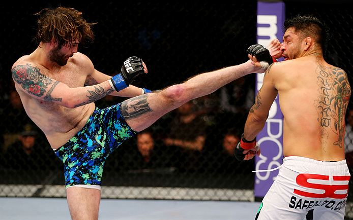 NEWARK, NJ - APRIL 27: Cody McKenzie (L) kicks Leonard Garcia (R) in their featherweight bout during the UFC 159 event at the Prudential Center on April 27, 2013 in Newark, New Jersey. (Photo by Al Bello/Zuffa LLC/Zuffa LLC Via Getty Images)