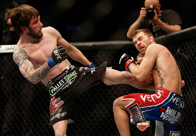 NEWARK, NJ - APRIL 27: (L-R) Johny Bedford kicks Bryan Caraway in their bantamweight fight during the UFC 159 event at the Prudential Center on April 27, 2013 in Newark, New Jersey. (Photo by Josh Hedges/Zuffa LLC/Zuffa LLC via Getty Images)