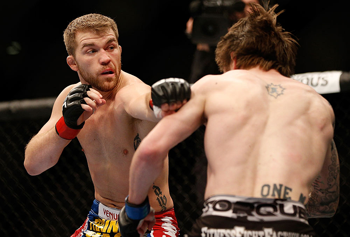 NEWARK, NJ - APRIL 27: (L-R) Bryan Caraway punches Johny Bedford in their bantamweight fight during the UFC 159 event at the Prudential Center on April 27, 2013 in Newark, New Jersey. (Photo by Josh Hedges/Zuffa LLC/Zuffa LLC via Getty Images)