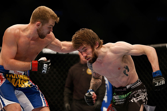 NEWARK, NJ - APRIL 27: (L-R) Bryan Caraway punches Johny Bedford in their bantamweight fight during the UFC 159 event at the Prudential Center on April 27, 2013 in Newark, New Jersey. (Photo by Josh Hedges/Zuffa LLC/Zuffa LLC via Getty Images)