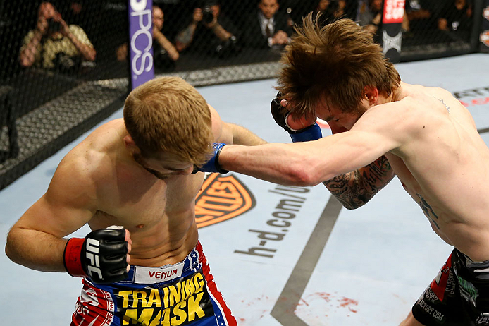 NEWARK, NJ - APRIL 27: Johnny Bedford (R) punches Bryan Caraway (L) in their bantamweight bout during the UFC 159 event at the Prudential Center on April 27, 2013 in Newark, New Jersey. (Photo by Al Bello/Zuffa LLC/Zuffa LLC Via Getty Images)