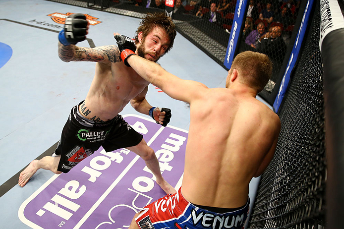 NEWARK, NJ - APRIL 27: (L-R) Johnny Bedford and Bryan Caraway exchange punches in their bantamweight bout during the UFC 159 event at the Prudential Center on April 27, 2013 in Newark, New Jersey. (Photo by Al Bello/Zuffa LLC/Zuffa LLC Via Getty Images)