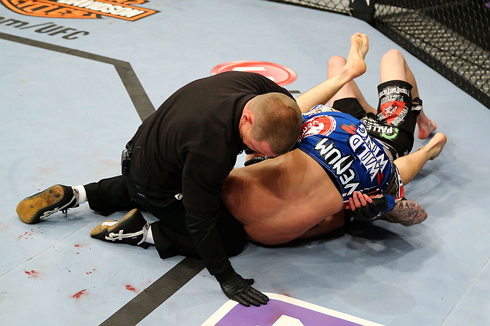 NEWARK, NJ - APRIL 27: Bryan Caraway submits Johnny Bedford with a guillotine choke as the referee calls the match in their bantamweight bout during the UFC 159 event at the Prudential Center on April 27, 2013 in Newark, New Jersey. (Photo by Al Bello/