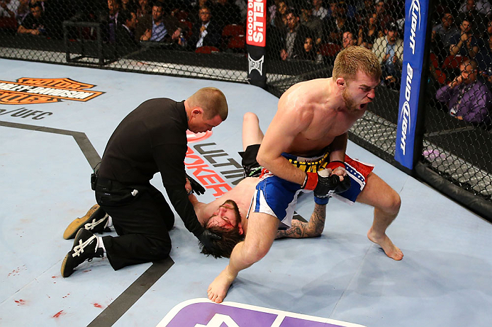 NEWARK, NJ - APRIL 27: Bryan Caraway (R) celebrates winning by submission (guillotine choke) against Johnny Bedford (C) in their bantamweight bout during the UFC 159 event at the Prudential Center on April 27, 2013 in Newark, New Jersey. (Photo by Al Be