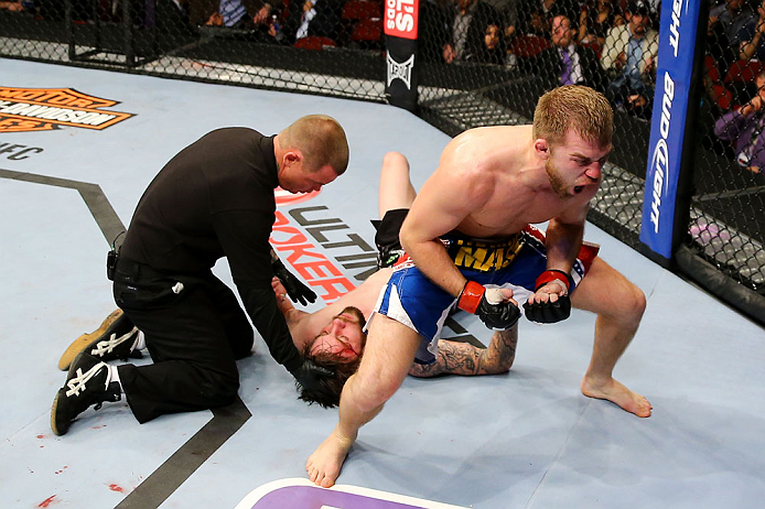 NEWARK, NJ - APRIL 27: Bryan Caraway (R) celebrates winning by submission (guillotine choke) against Johnny Bedford (C) in their bantamweight bout during the UFC 159 event at the Prudential Center on April 27, 2013 in Newark, New Jersey. (Photo by Al Be