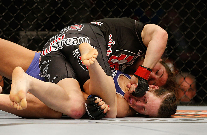 NEWARK, NJ - APRIL 27: Sara McMann (top) punches Sheila Gaff in their bantamweight fight during the UFC 159 event at the Prudential Center on April 27, 2013 in Newark, New Jersey. (Photo by Josh Hedges/Zuffa LLC/Zuffa LLC via Getty Images)