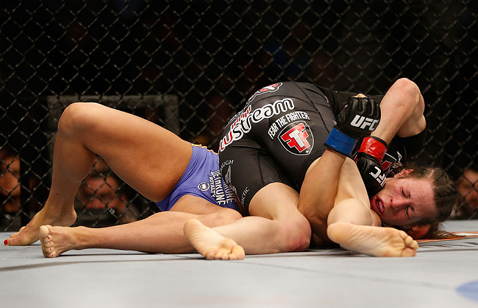 NEWARK, NJ - APRIL 27: Sara McMann (top) punches Sheila Gaff in their bantamweight fight during the UFC 159 event at the Prudential Center on April 27, 2013 in Newark, New Jersey. (Photo by Josh Hedges/Zuffa LLC/Zuffa LLC via Getty Images)