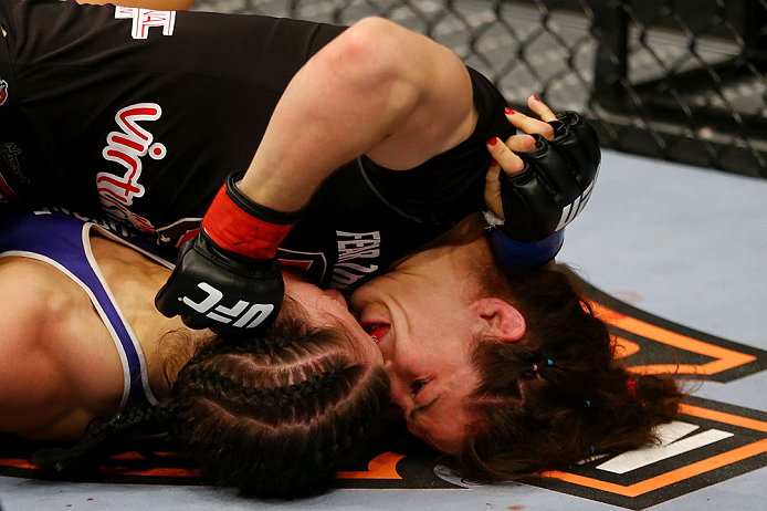 NEWARK, NJ - APRIL 27: Sara McMann punches Sheila Gaff in round one of their women's bantamweight bout during the UFC 159 event at the Prudential Center on April 27, 2013 in Newark, New Jersey. (Photo by Al Bello/Zuffa LLC/Zuffa LLC Via Getty Images)