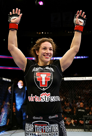 NEWARK, NJ - APRIL 27: Sara McMann celebrates defeating Sheila Gaff by KO/TKO in round one of their women's bantamweight bout during the UFC 159 event at the Prudential Center on April 27, 2013 in Newark, New Jersey. (Photo by Al Bello/Zuffa LLC/Zuffa L