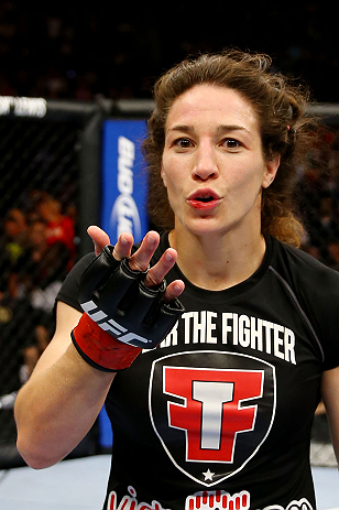 NEWARK, NJ - APRIL 27: Sara McMann celebrates defeating Sheila Gaff by KO/TKO in round one of their women's bantamweight bout during the UFC 159 event at the Prudential Center on April 27, 2013 in Newark, New Jersey. (Photo by Al Bello/Zuffa LLC/Zuffa L