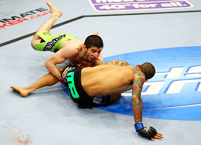NEWARK, NJ - APRIL 27: (L-R) Rustam Khabilov of Russia takes down Yancy Medeiros who breaks his fall with his hands injuring himself in their lightweight bout during the UFC 159 event at the Prudential Center on April 27, 2013 in Newark, New Jersey. (Ph