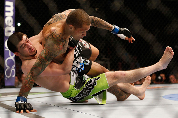 NEWARK, NJ - APRIL 27: (L-R) Rustam Khabilov takes down Yancy Medeiros in their lightweight fight during the UFC 159 event at the Prudential Center on April 27, 2013 in Newark, New Jersey. (Photo by Josh Hedges/Zuffa LLC/Zuffa LLC via Getty Images)