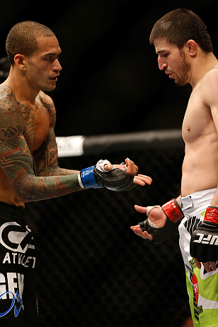 NEWARK, NJ - APRIL 27: (L-R) Yancy Medeiros shows opponent Rustam Khabilov his dislocated thumb suffered in their lightweight fight during the UFC 159 event at the Prudential Center on April 27, 2013 in Newark, New Jersey. (Photo by Josh Hedges/Zuffa L