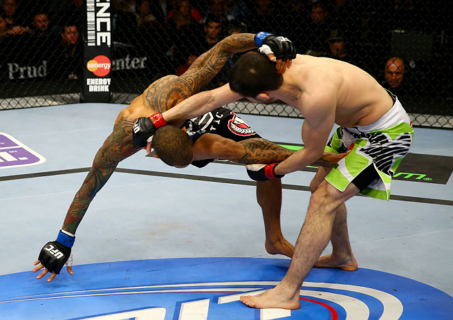 NEWARK, NJ - APRIL 27: Rustam Khabilov (R) of Russia grabs the leg of Yancy Medeiros (L) in their lightweight bout during the UFC 159 event at the Prudential Center on April 27, 2013 in Newark, New Jersey. (Photo by Al Bello/Zuffa LLC/Zuffa LLC Via Getty