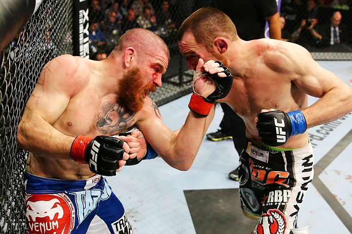 NEWARK, NJ - APRIL 27: (L-R) Jim Miller and Pat Healy exchange punches in their lightweight bout during the UFC 159 event at the Prudential Center on April 27, 2013 in Newark, New Jersey. (Photo by Al Bello/Zuffa LLC/Zuffa LLC Via Getty Images)